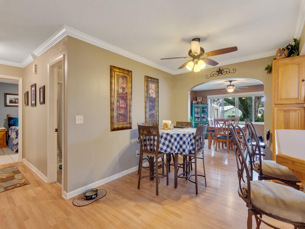 3118 Old Edwards Road Fort Pierce, FL 34981 - Photo 12 of 35 a view of a dining room with furniture window and wooden floor