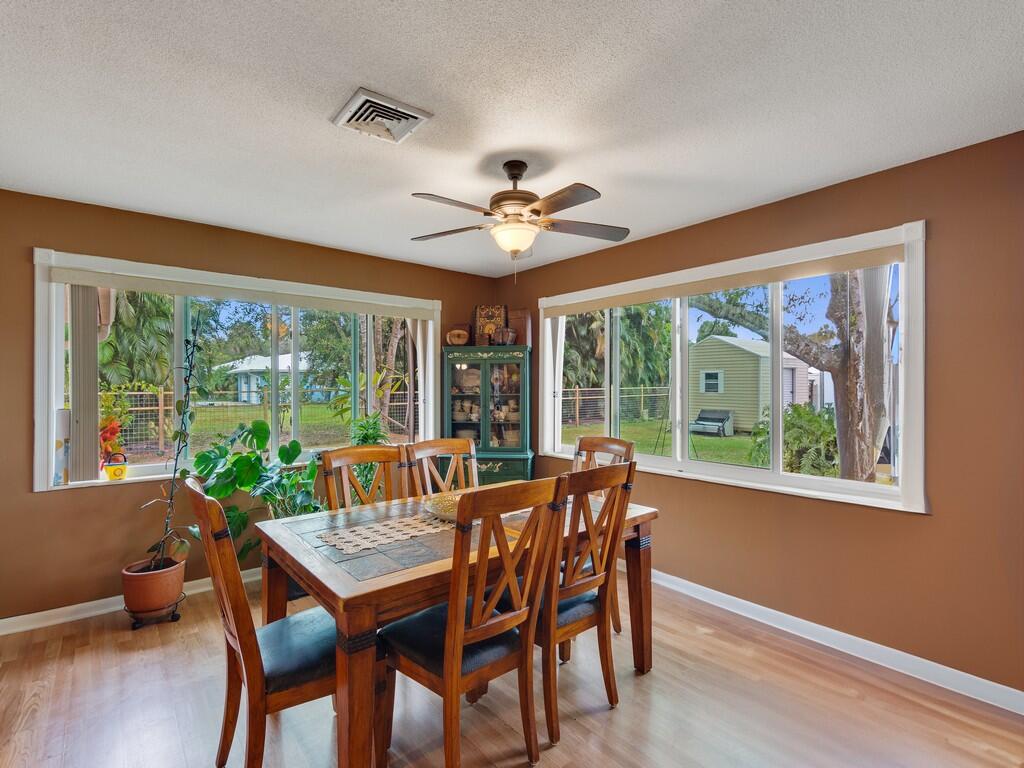 3118 Old Edwards Road Fort Pierce, FL 34981 - Photo 14 of 35 a dining room with furniture window and wooden floor