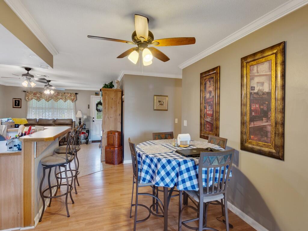 3118 Old Edwards Road Fort Pierce, FL 34981 - Photo 15 of 35 a view of a dining room with furniture and chandelier