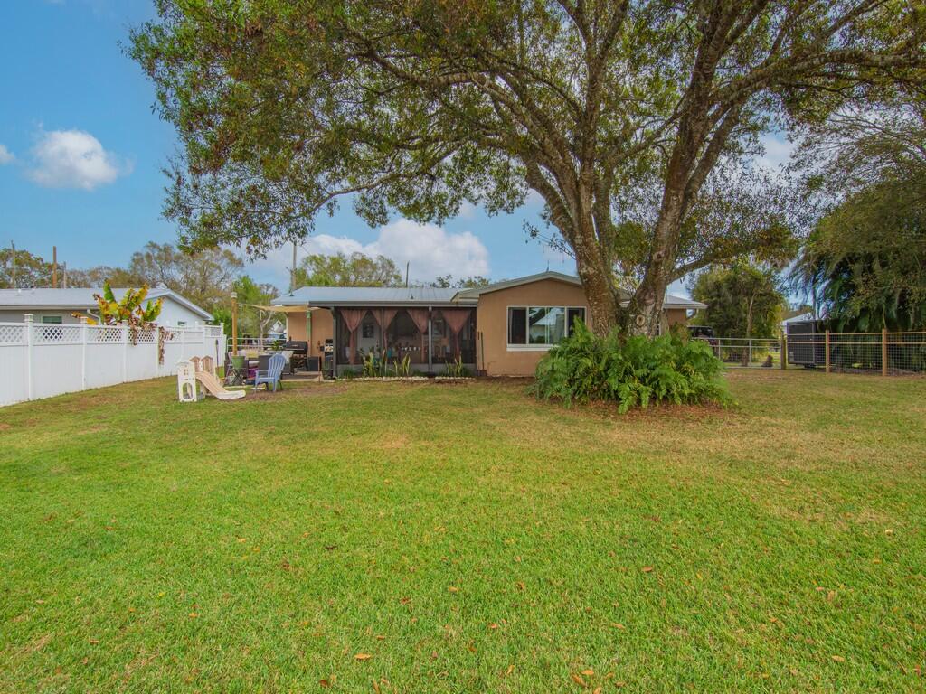 3118 Old Edwards Road Fort Pierce, FL 34981 - Photo 25 of 35 a front view of a house with a garden