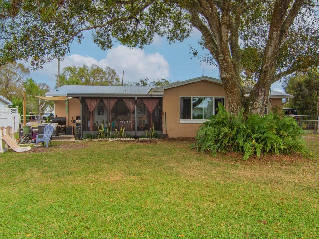 3118 Old Edwards Road Fort Pierce, FL 34981 - Photo 26 of 35 a front view of house with yard and green space
