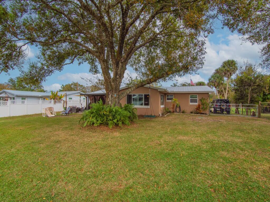 3118 Old Edwards Road Fort Pierce, FL 34981 - Photo 28 of 35 a front view of a house with a garden