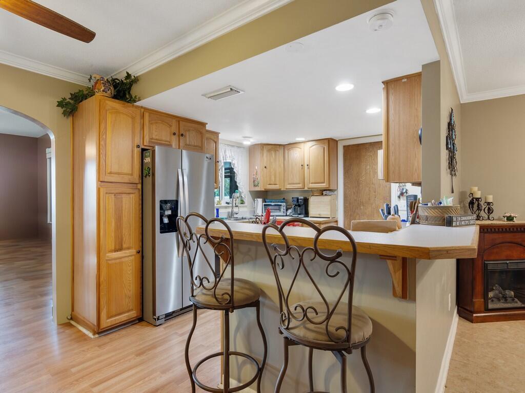 3118 Old Edwards Road Fort Pierce, FL 34981 - Photo 3 of 35 a kitchen with stainless steel appliances refrigerator dining table and chairs