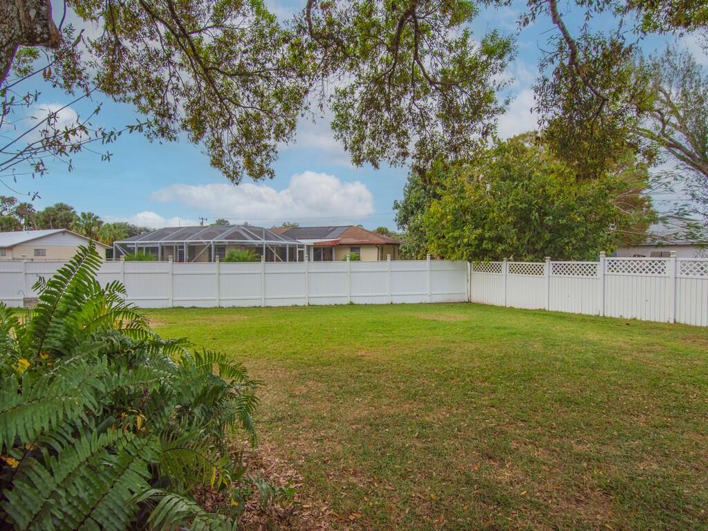 3118 Old Edwards Road Fort Pierce, FL 34981 - Photo 31 of 35 a view of a swimming pool with a yard