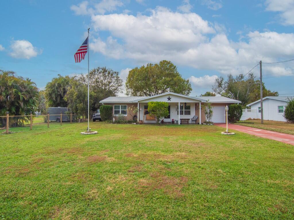 3118 Old Edwards Road Fort Pierce, FL 34981 - Photo 32 of 35 a front view of a house with a garden