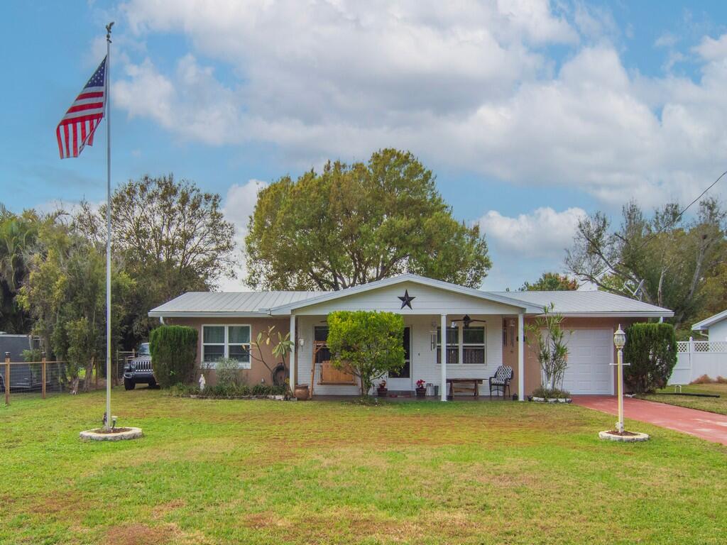 3118 Old Edwards Road Fort Pierce, FL 34981 - Photo 33 of 35 a front view of a house with a garden