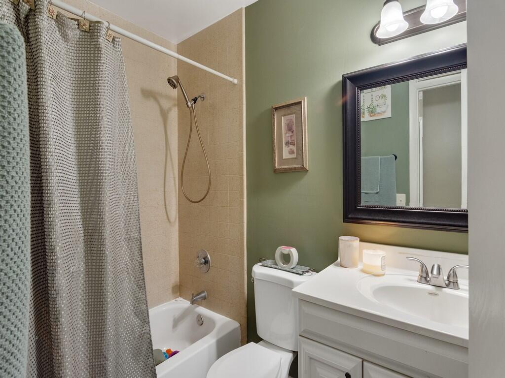 3118 Old Edwards Road Fort Pierce, FL 34981 - Photo 6 of 35 a bathroom with a sink a toilet and shower