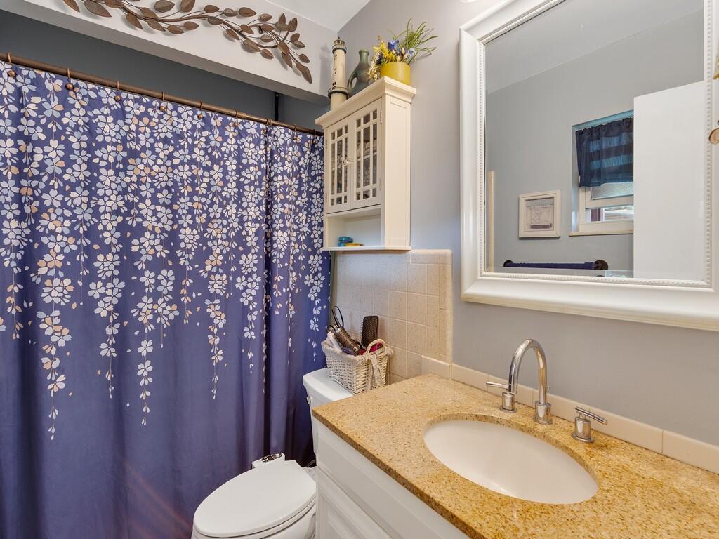 3118 Old Edwards Road Fort Pierce, FL 34981 - Photo 7 of 35 a bathroom with a sink toilet and mirror