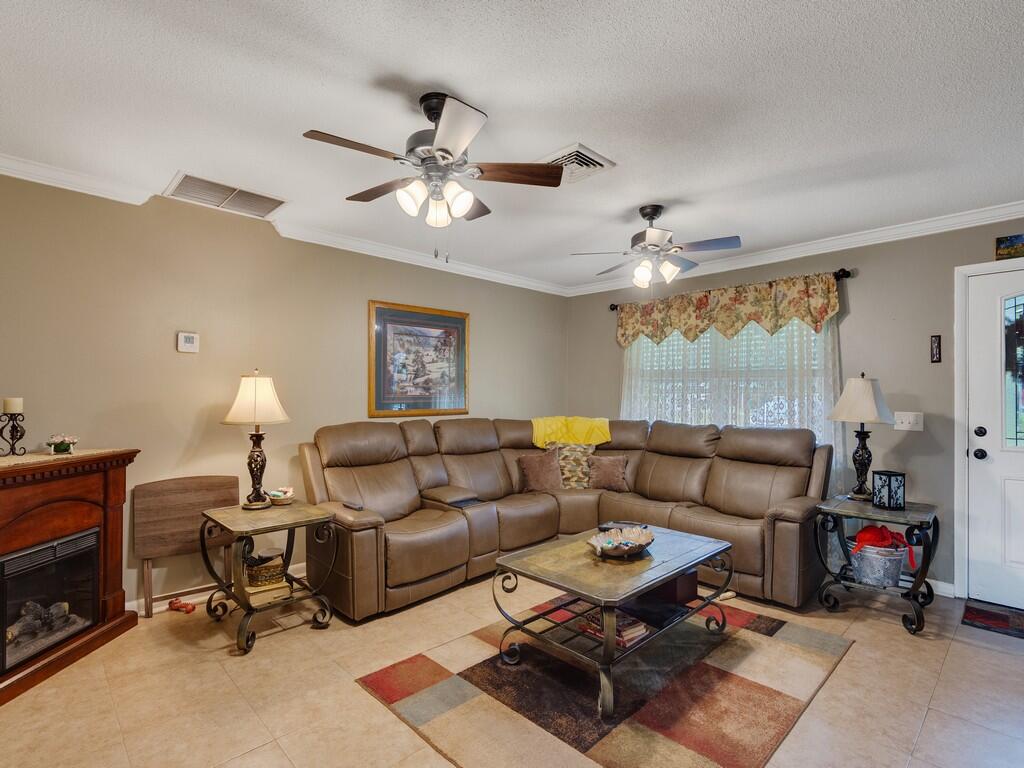 3118 Old Edwards Road Fort Pierce, FL 34981 - Photo 8 of 35 a living room with furniture and a fireplace