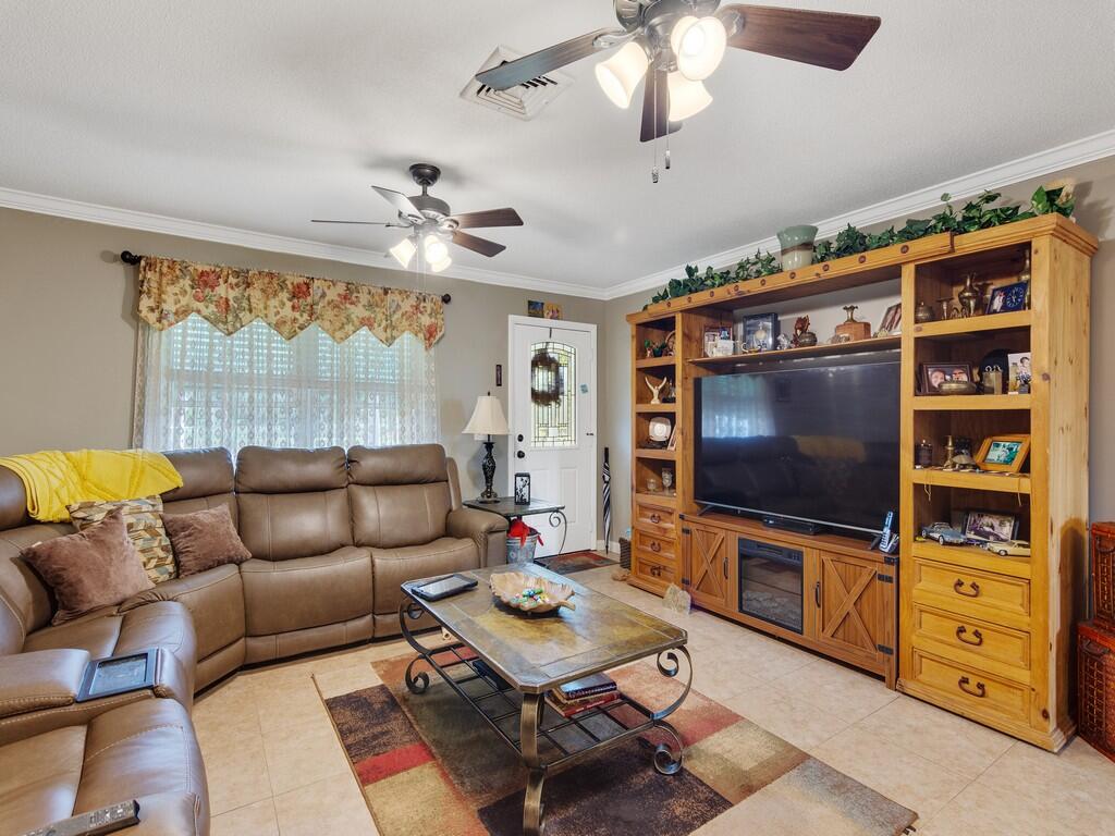 3118 Old Edwards Road Fort Pierce, FL 34981 - Photo 9 of 35 a living room with furniture and a flat screen tv