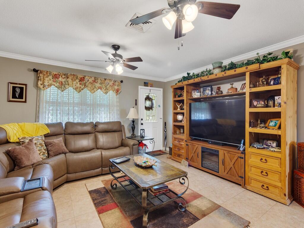 3118 Old Edwards Road Fort Pierce, FL 34981 - Photo 10 of 35 a living room with furniture and a flat screen tv