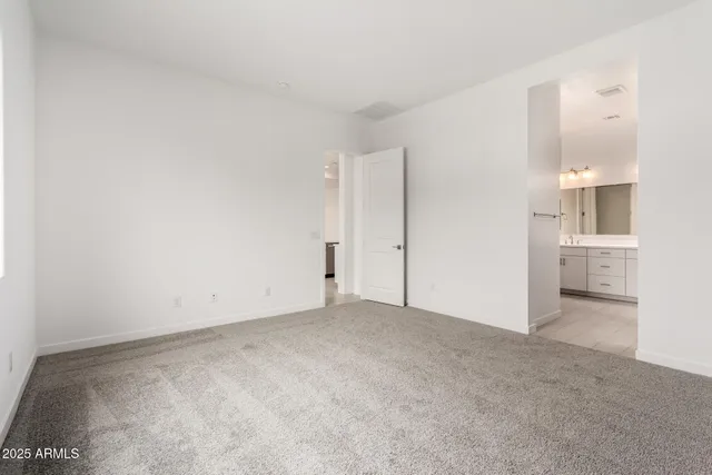 a spacious bathroom with a double vanity sink a mirror and a shower