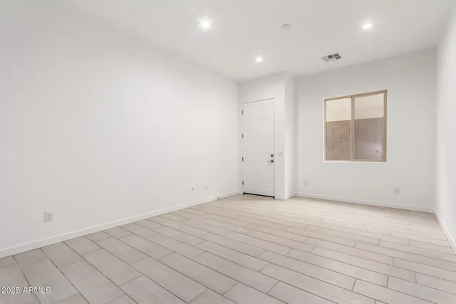 an empty room with windows and closet