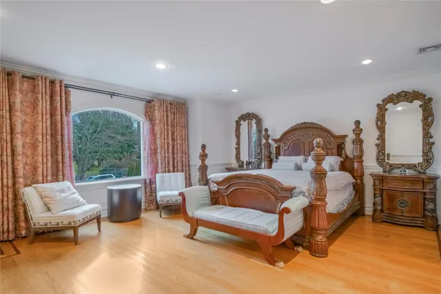 a bedroom with furniture and a large window