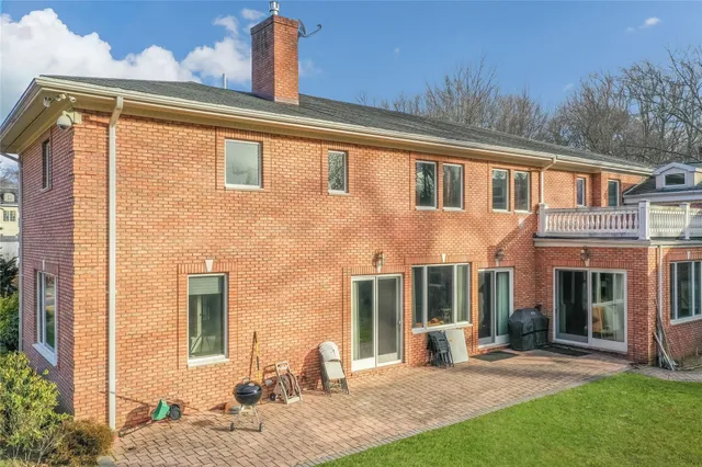 a front view of a house with a yard table and chairs