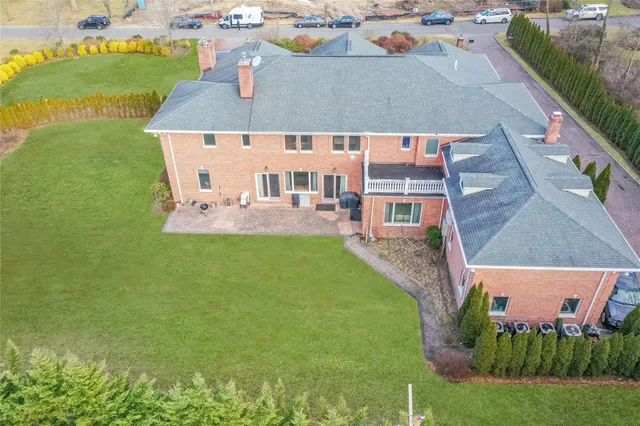 an aerial view of a house with a garden and swimming pool