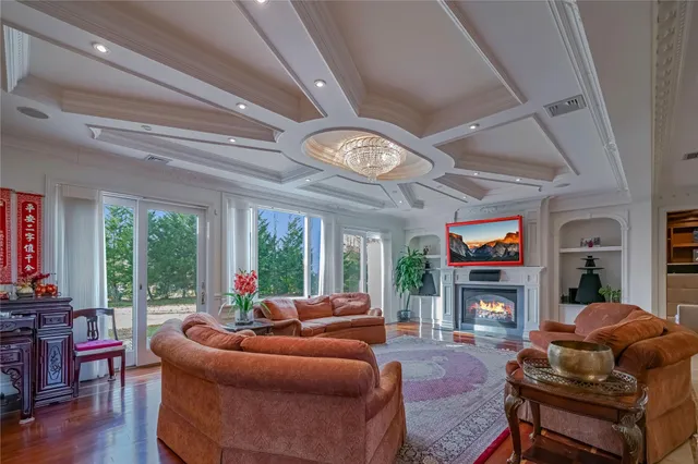 a living room with furniture a fireplace and a large window