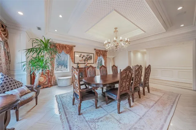 a view of a dining room with furniture and a chandelier