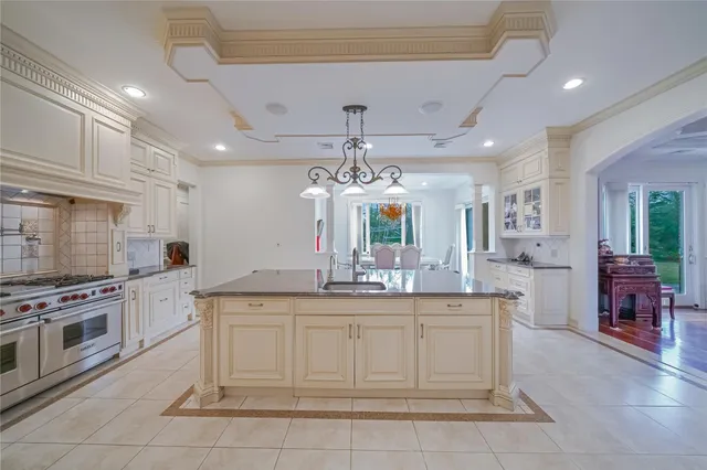 a kitchen with a stove kitchen island and stainless steel appliances