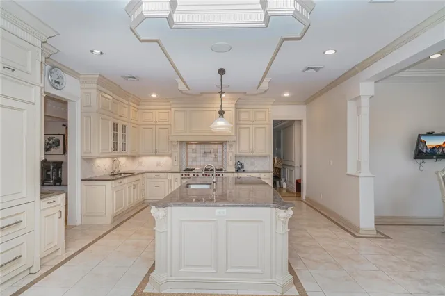 a kitchen with refrigerator and cabinets