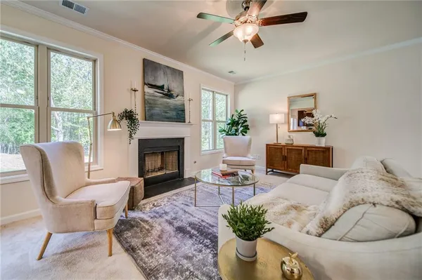 a living room with furniture kitchen view and a chandelier