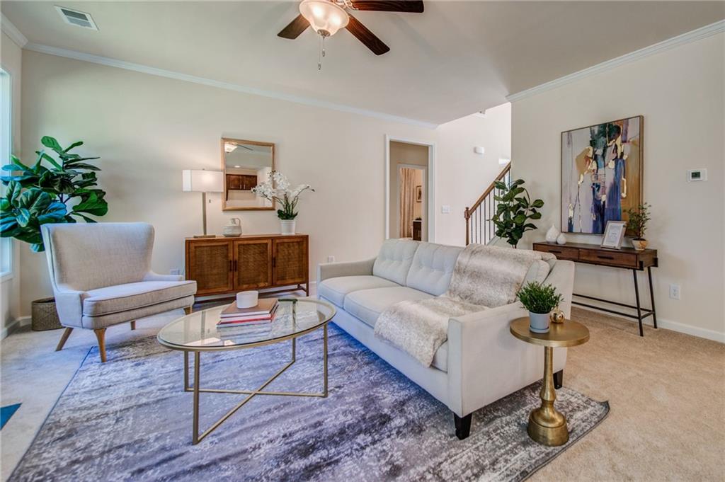 3430 South Scales Road Duluth, GA 30097 - Photo 17 of 77 a living room with furniture and a potted plant