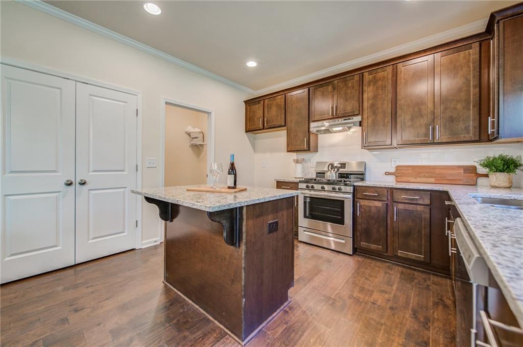 3430 South Scales Road Duluth, GA 30097 - Photo 25 of 77 a kitchen with granite countertop a sink stove and refrigerator