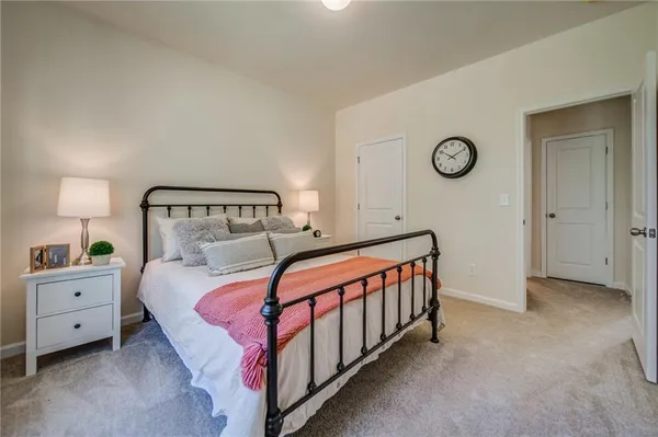 a spacious bedroom with a bed a couch and a window