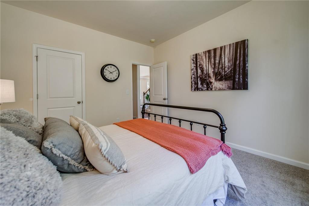 3430 South Scales Road Duluth, GA 30097 - Photo 35 of 77 a bedroom with a bed and a painting on the wall
