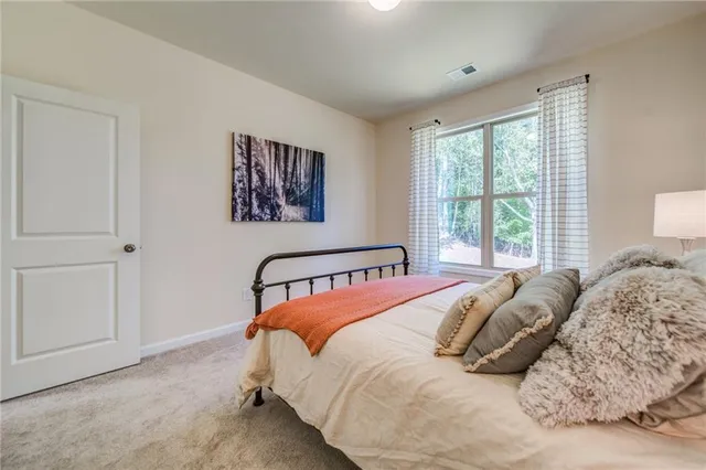 a spacious bedroom with a bed and furniture