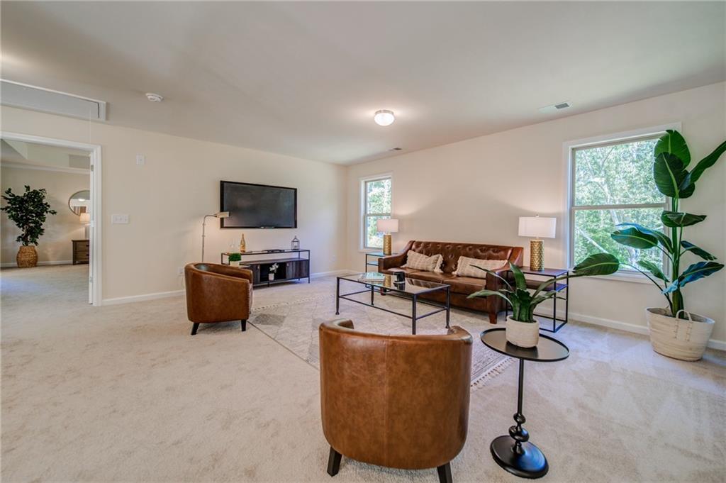 3430 South Scales Road Duluth, GA 30097 - Photo 45 of 77 a living room with furniture a flat screen tv and a potted plant