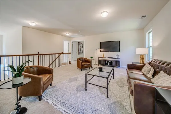 a view of balcony with wooden floor and seating space