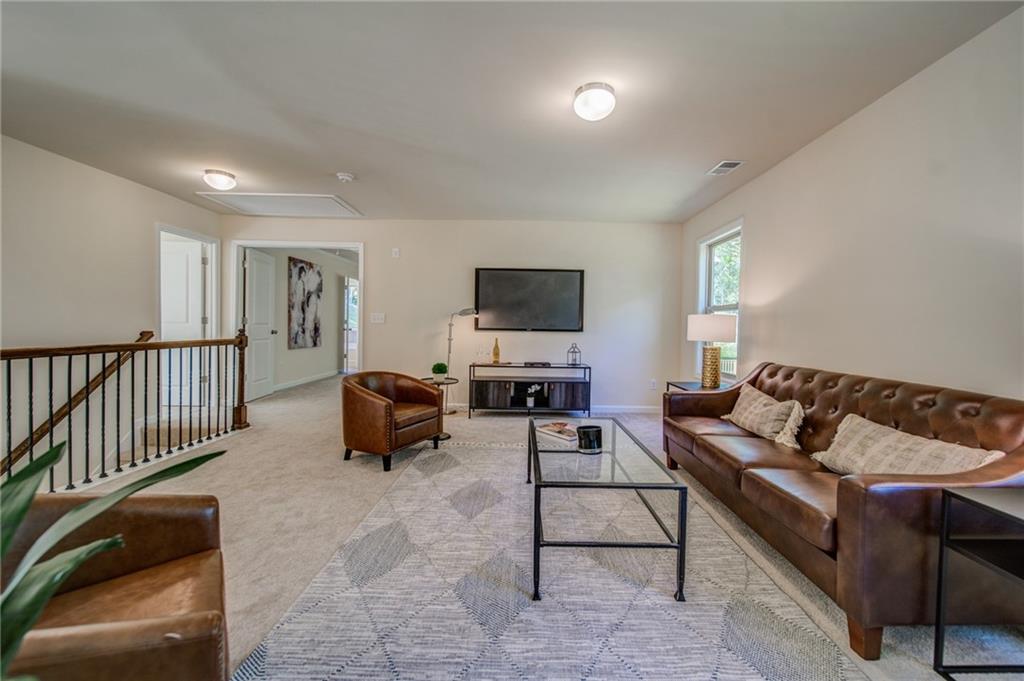 3430 South Scales Road Duluth, GA 30097 - Photo 47 of 77 a living room with furniture and a flat screen tv