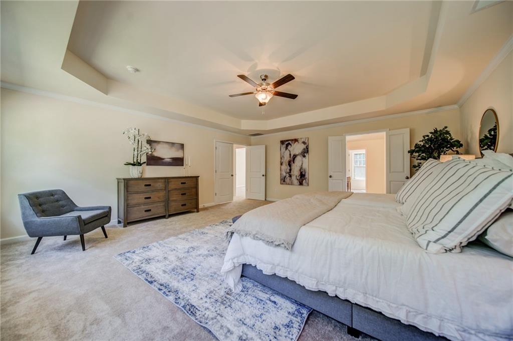 3430 South Scales Road Duluth, GA 30097 - Photo 55 of 77 a spacious bedroom with a bed and furniture