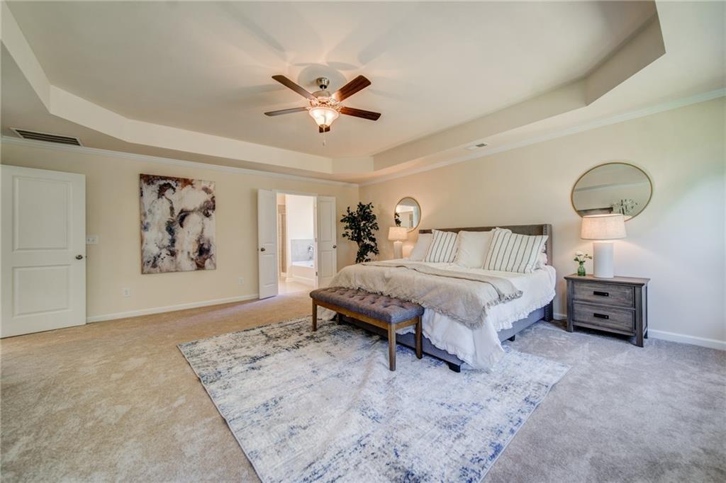 3430 South Scales Road Duluth, GA 30097 - Photo 56 of 77 a bedroom with a bed and a chandelier