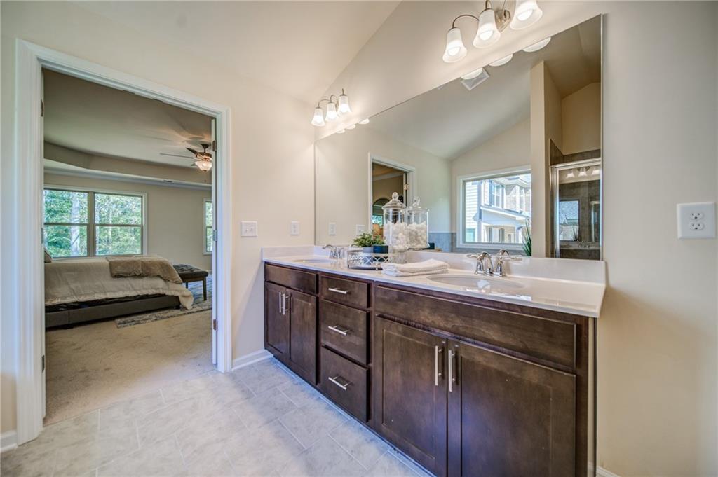 3430 South Scales Road Duluth, GA 30097 - Photo 59 of 77 a spacious bathroom with a granite countertop sink a large mirror and a vanity