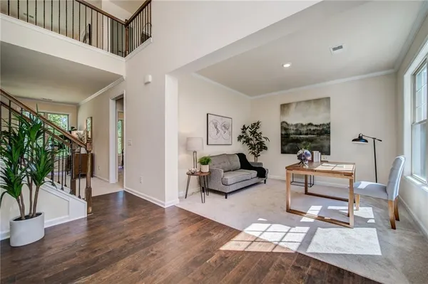a living room with furniture a table and a large window