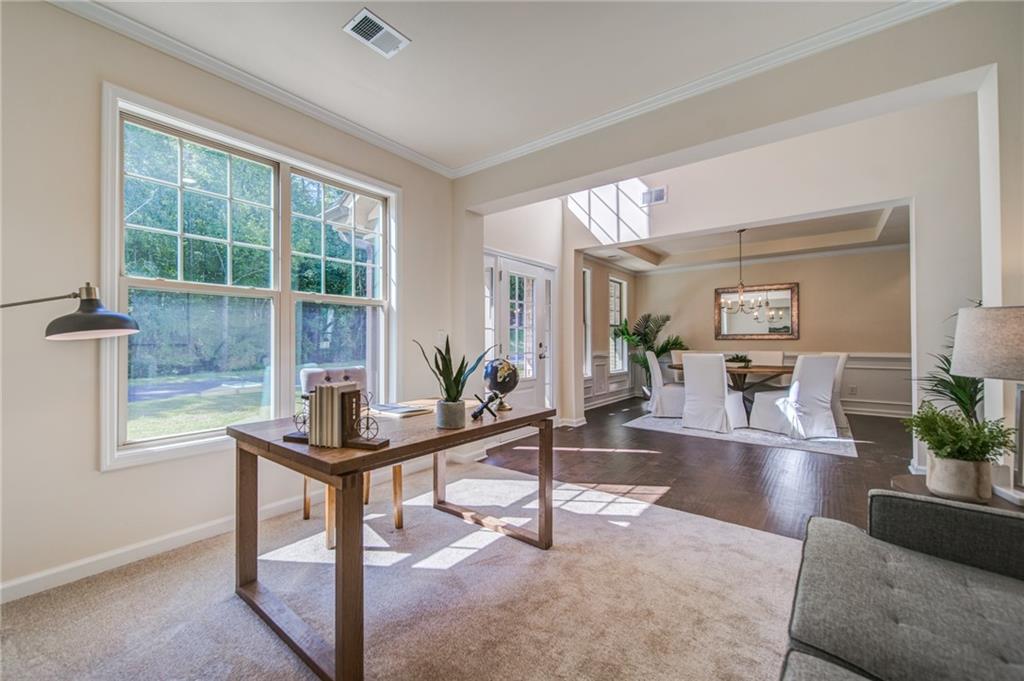 3430 South Scales Road Duluth, GA 30097 - Photo 10 of 77 a living room with furniture a table and a large window
