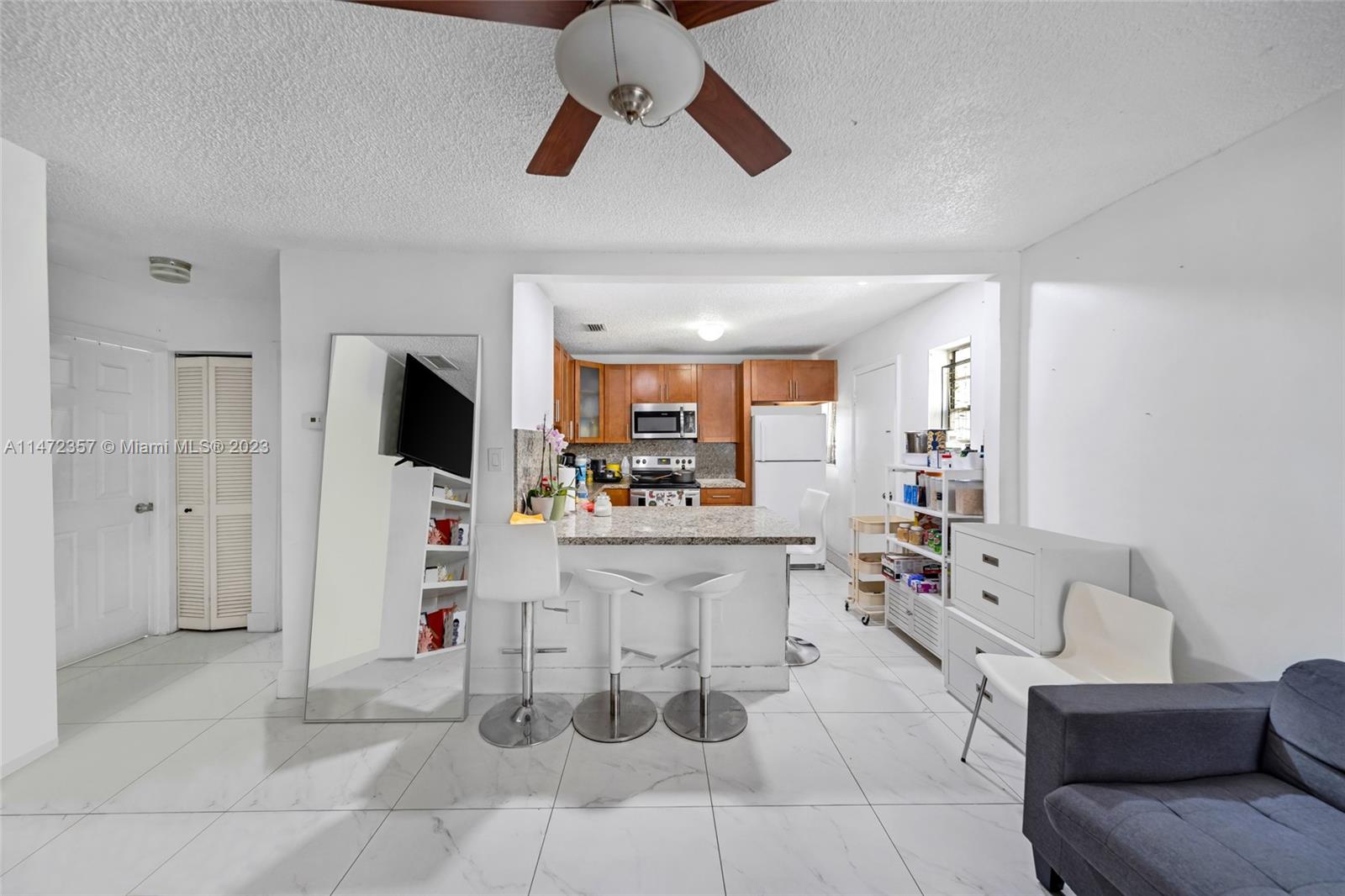 1137 Northwest 2nd Street Miami, FL 33128 - Photo 11 of 32 a view of kitchen with stainless steel appliances kitchen island dining table and chairs