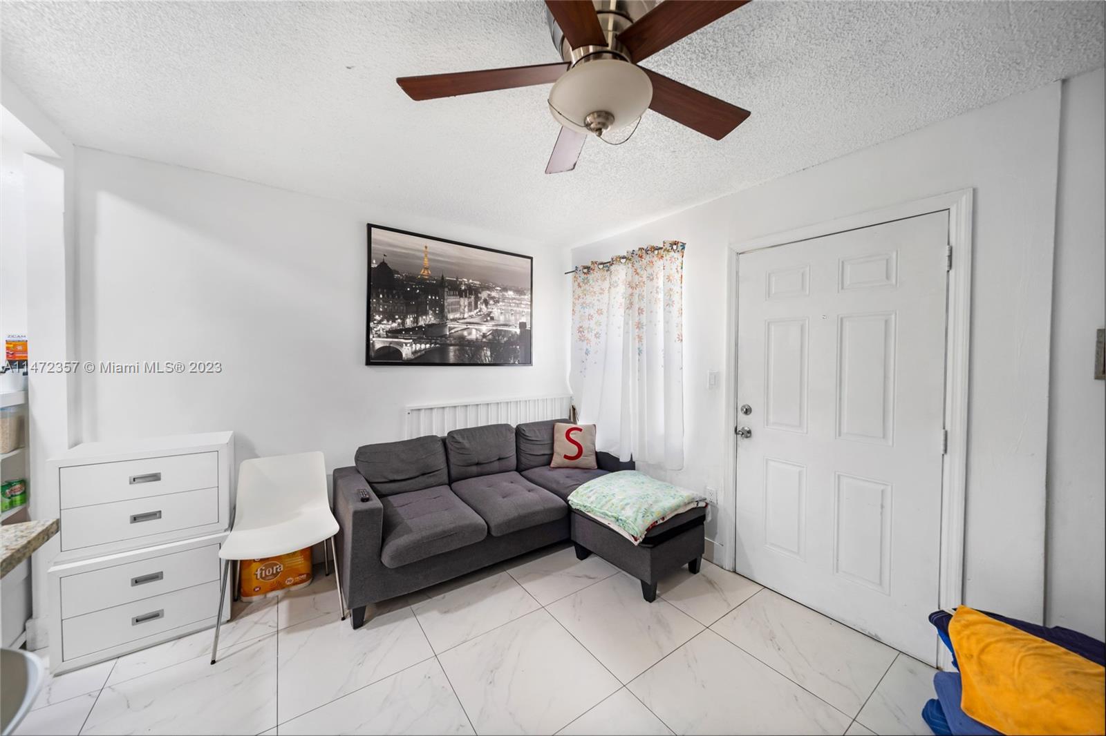 1137 Northwest 2nd Street Miami, FL 33128 - Photo 13 of 32 a living room with furniture and a baby crib