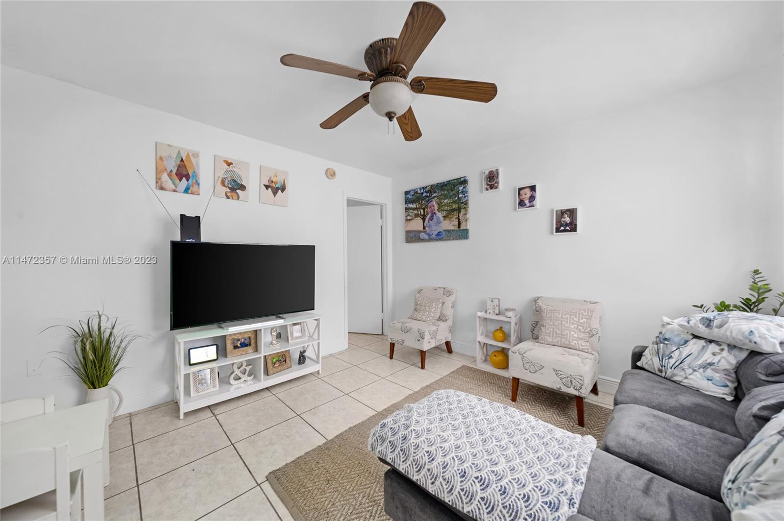 1137 Northwest 2nd Street Miami, FL 33128 - Photo 17 of 32 a living room with furniture and a flat screen tv