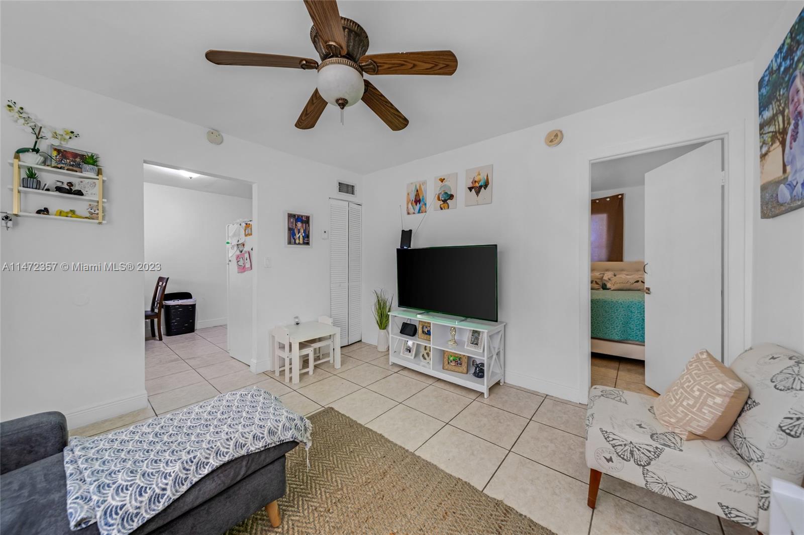 1137 Northwest 2nd Street Miami, FL 33128 - Photo 19 of 32 a living room with furniture and a flat screen tv