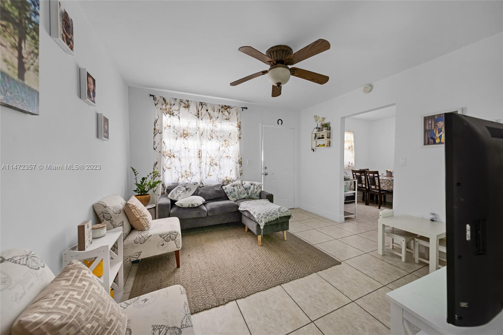 1137 Northwest 2nd Street Miami, FL 33128 - Photo 20 of 32 a living room with furniture and a flat screen tv