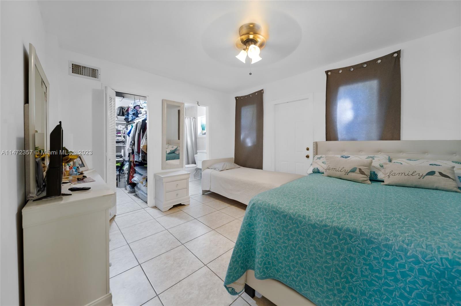 1137 Northwest 2nd Street Miami, FL 33128 - Photo 22 of 32 a bedroom with a bed a couch and dresser