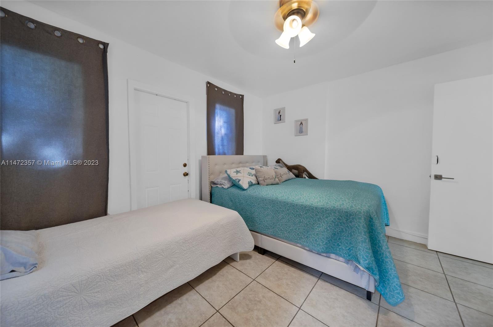 1137 Northwest 2nd Street Miami, FL 33128 - Photo 23 of 32 a bedroom with a bed and a chandelier