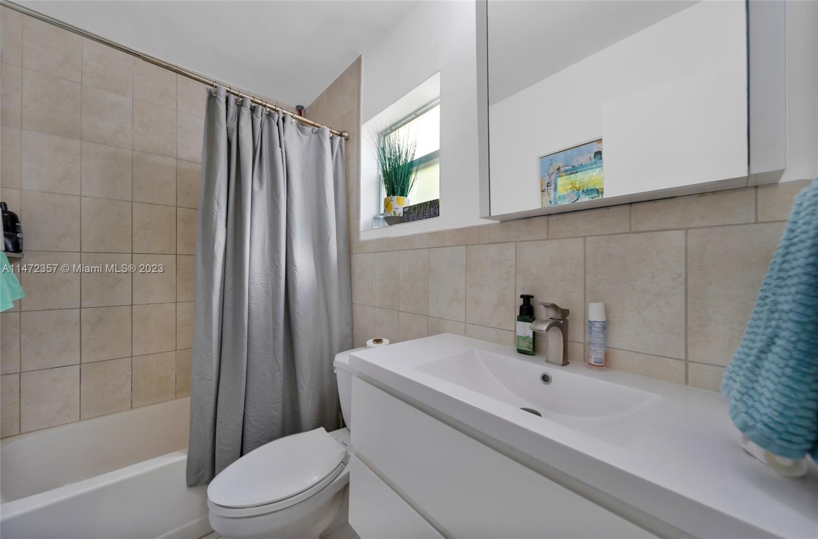 1137 Northwest 2nd Street Miami, FL 33128 - Photo 25 of 32 a bathroom with a sink toilet and shower