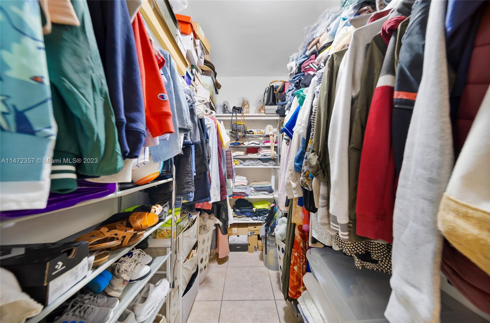 1137 Northwest 2nd Street Miami, FL 33128 - Photo 26 of 32 a view of walk in closet with clothes and shoes