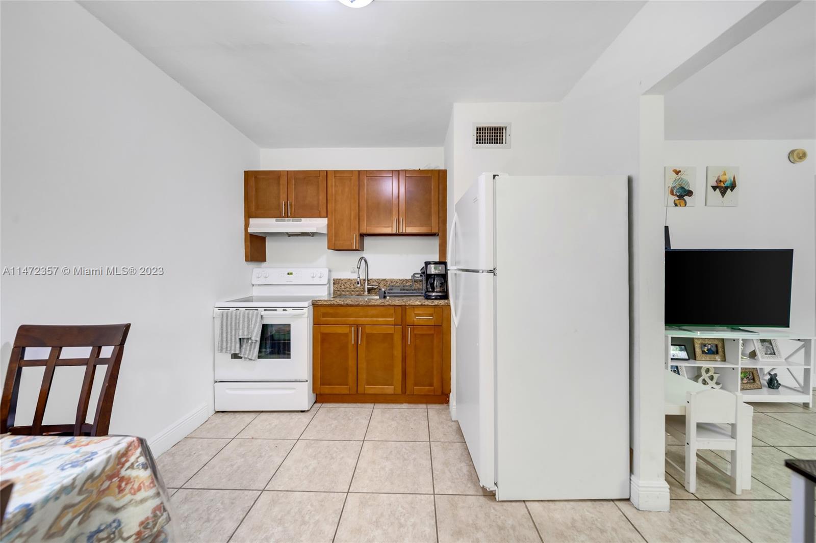 1137 Northwest 2nd Street Miami, FL 33128 - Photo 29 of 32 a view of kitchen with sink microwave and refrigerator