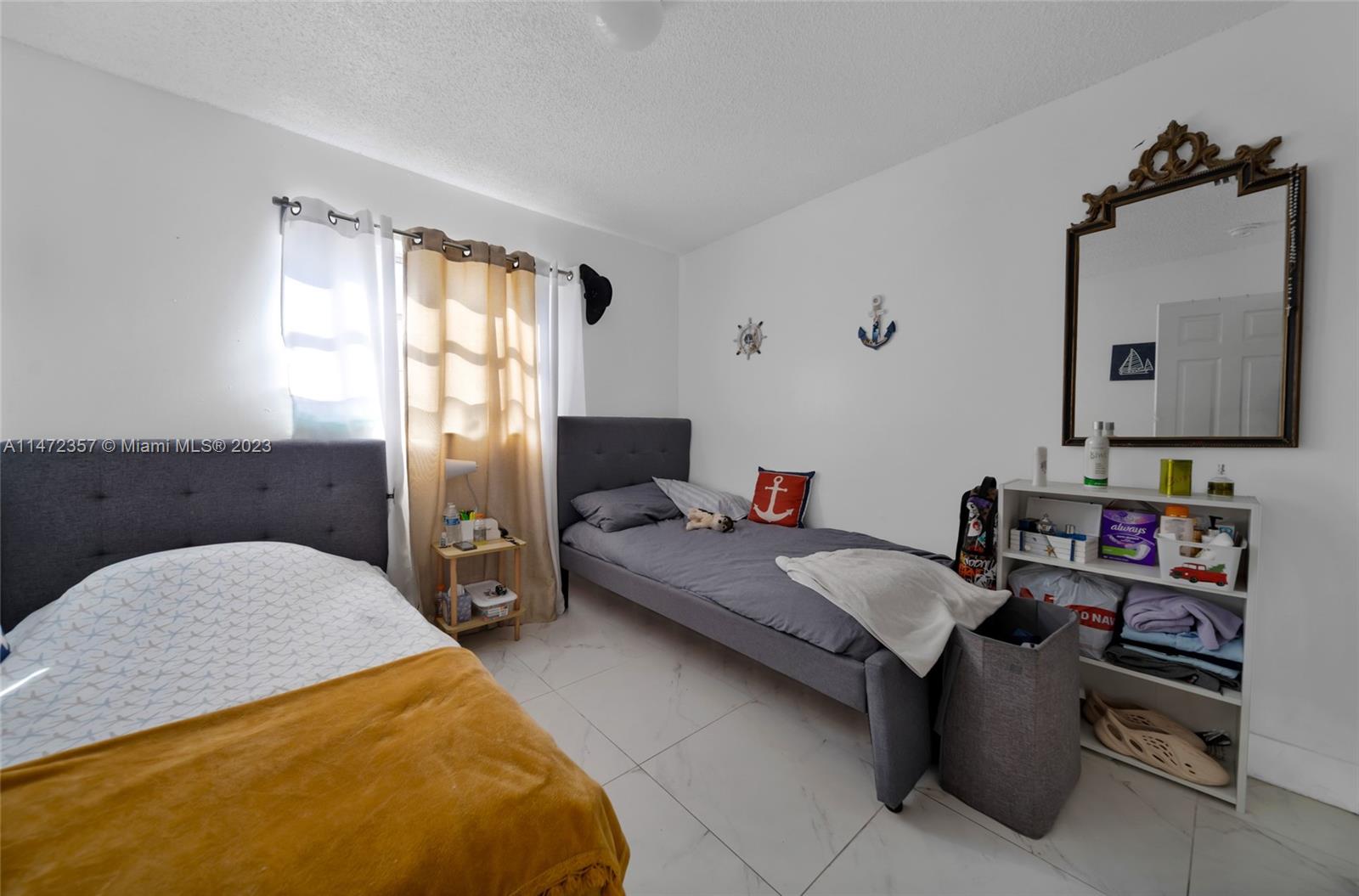 1137 Northwest 2nd Street Miami, FL 33128 - Photo 8 of 32 a en suite bathroom with a granite countertop sink and a mirror
