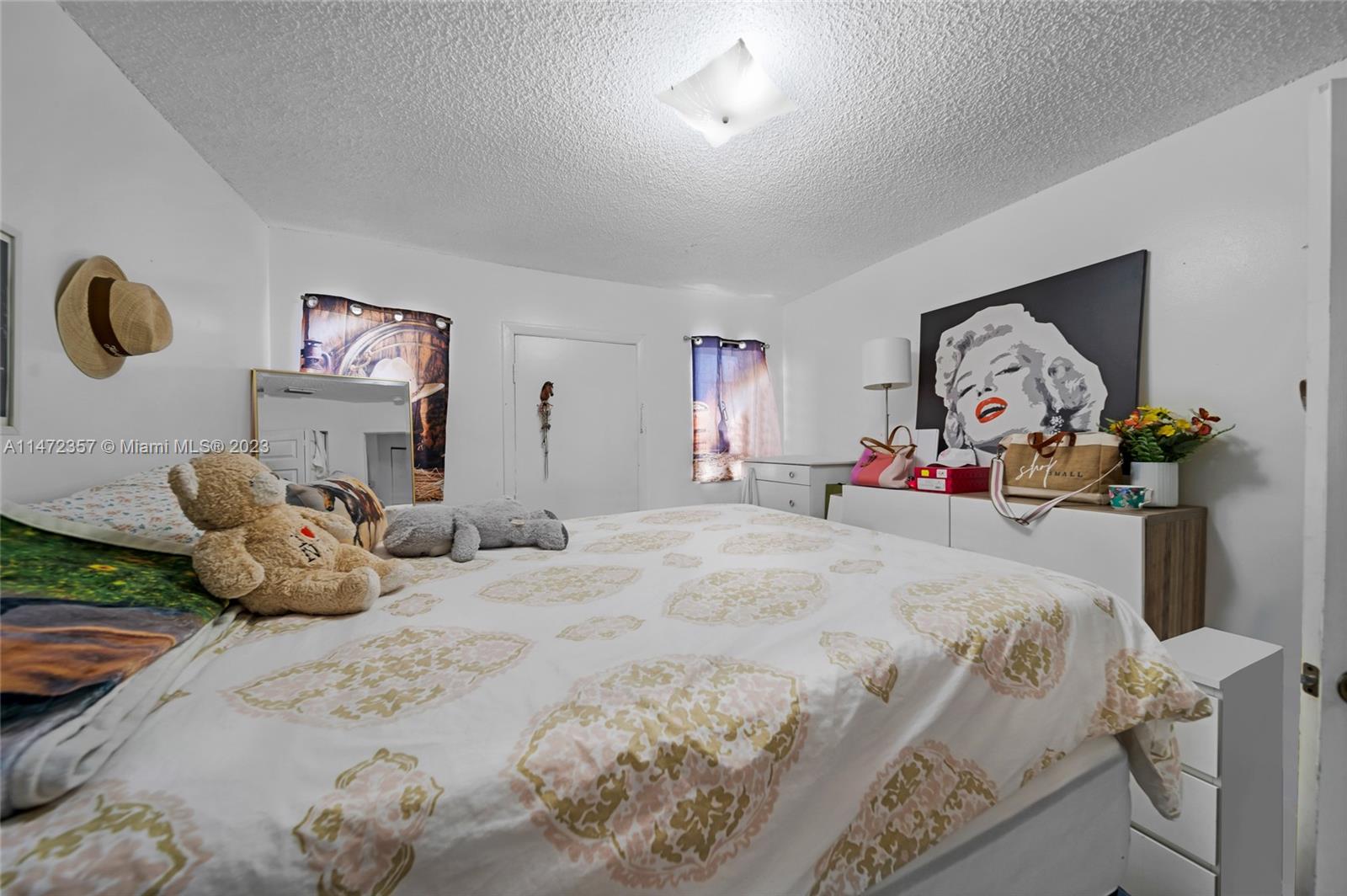 1137 Northwest 2nd Street Miami, FL 33128 - Photo 10 of 32 a bedroom with a bed and a couch